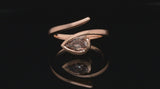 'Twist' rose gold engagement ring with pear shaped cognac diamond
